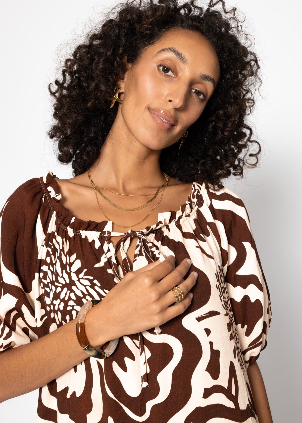 Volant dress with a large floral pressure - brown
