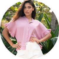 Women's pink muslin blouse with ruffled sleeves and a cropped fit, styled with white pants – pink muslin blouses by SASSYCLASSY