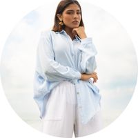 Women's white muslin pants with a wide cut, flowing fabric, and an elastic waistband, styled with a light blue muslin blouse - Muslin pants by SASSYCLASSY