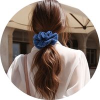 Women's blue velvet scrunchie worn as a hair tie – Scrunchies by SASSYCLASSY 
