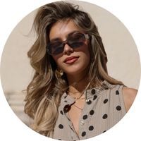 Women's sunglasses in dark brown with wide, angular retro frames, styled with a polka-dot top and gold earrings – sunglasses by SASSYCLASSY