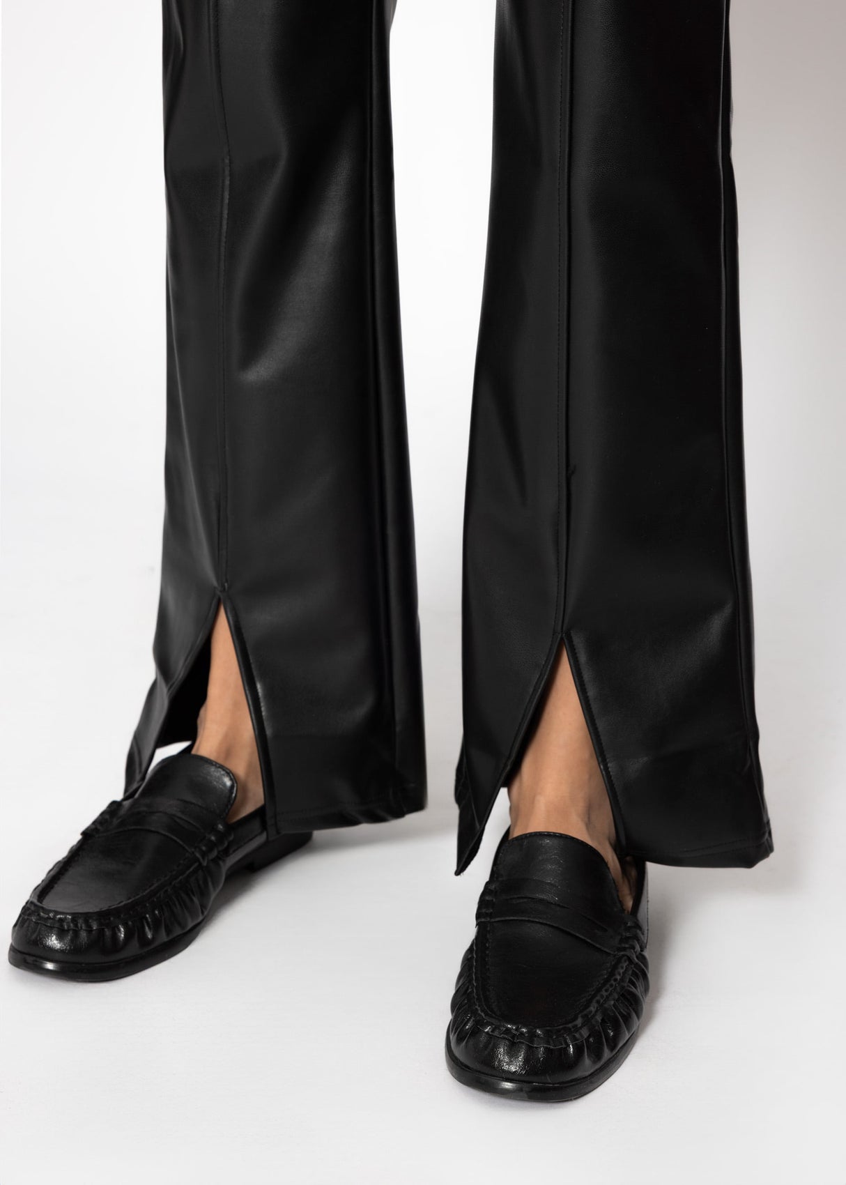 Faux leather thermal leggings with dividing seams and hem slit - black