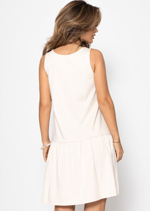 Sleeveless dress with flounce - beige