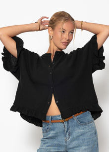 Musselin blouse with ruffled hem - black