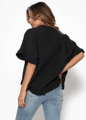 Musselin blouse with ruffled hem - black